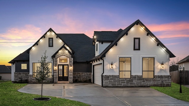 view of front facade with a garage and a lawn