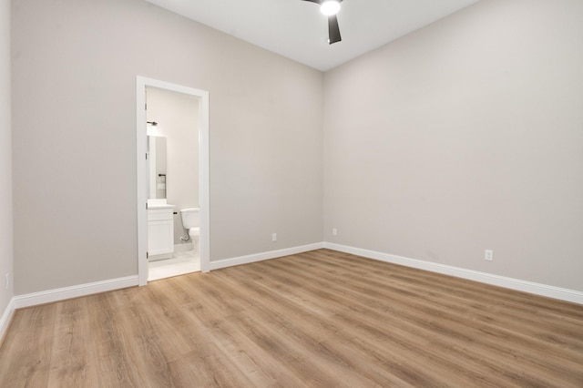 unfurnished bedroom with light hardwood / wood-style flooring, ceiling fan, and ensuite bathroom