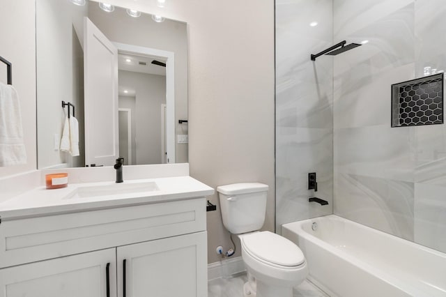 full bathroom featuring tiled shower / bath, vanity, and toilet