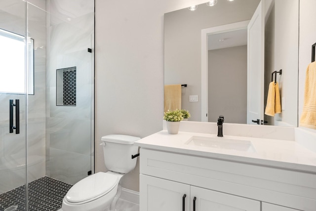 bathroom with vanity, toilet, and an enclosed shower