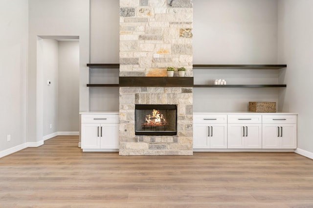 unfurnished living room featuring a fireplace and light hardwood / wood-style floors