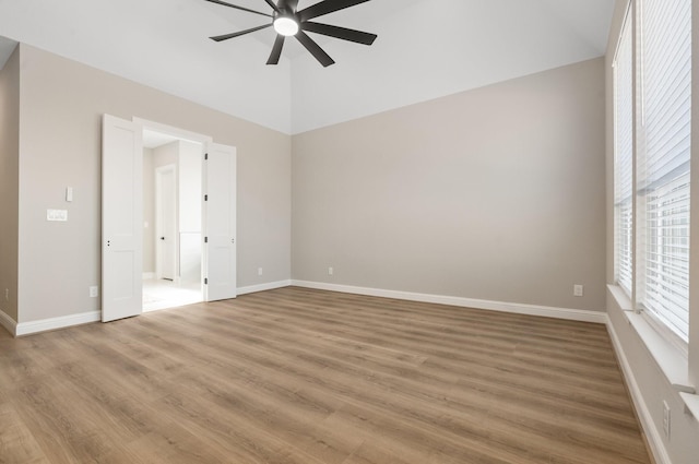 unfurnished room with hardwood / wood-style floors and ceiling fan