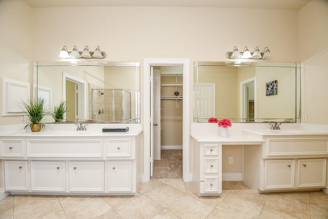 bathroom featuring vanity, tile patterned floors, and a shower with door