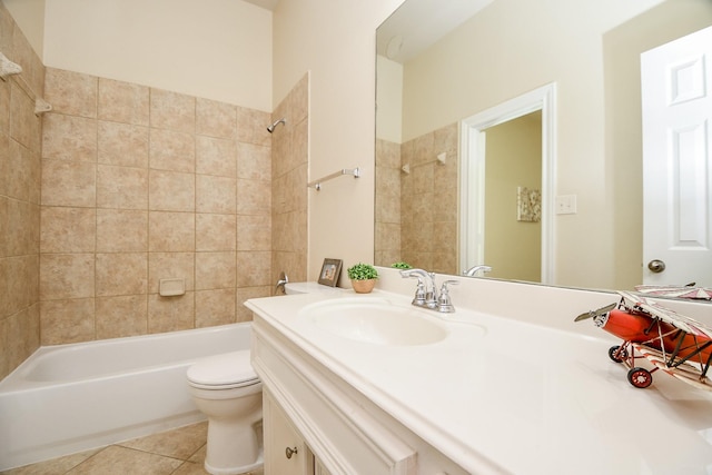 full bathroom with vanity, tiled shower / bath, tile patterned floors, and toilet