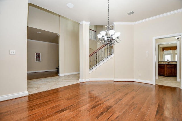 unfurnished dining area featuring crown molding, a chandelier, and light wood-type flooring