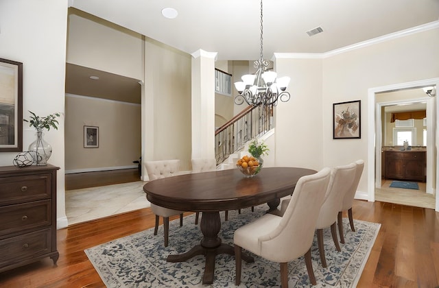 dining space featuring ornamental molding, an inviting chandelier, and dark hardwood / wood-style flooring