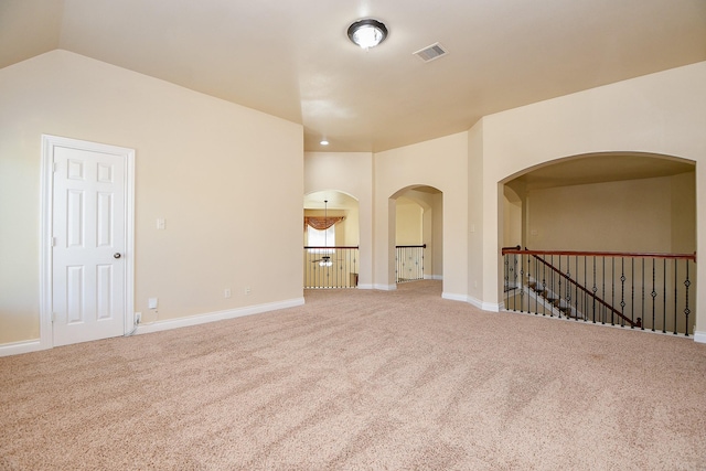 spare room with lofted ceiling and carpet flooring