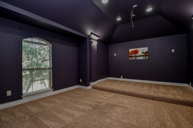 cinema room featuring lofted ceiling and carpet floors