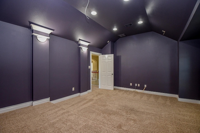 cinema featuring vaulted ceiling and carpet flooring