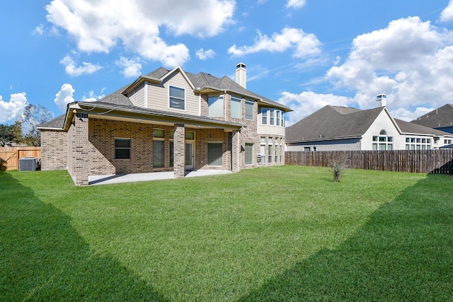 back of house featuring a yard, a patio area, and central air condition unit