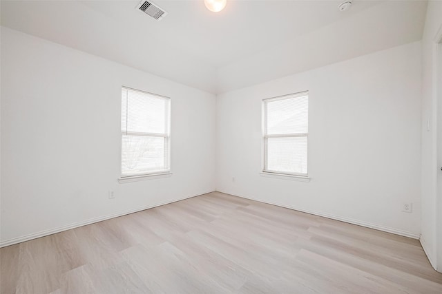 spare room with light hardwood / wood-style floors