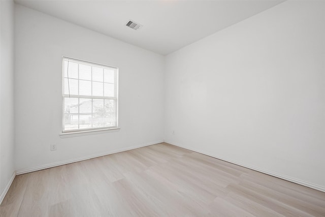 unfurnished room with light wood-type flooring