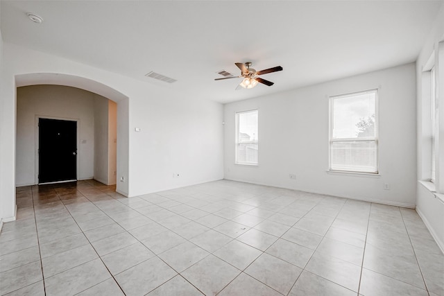 tiled empty room with ceiling fan