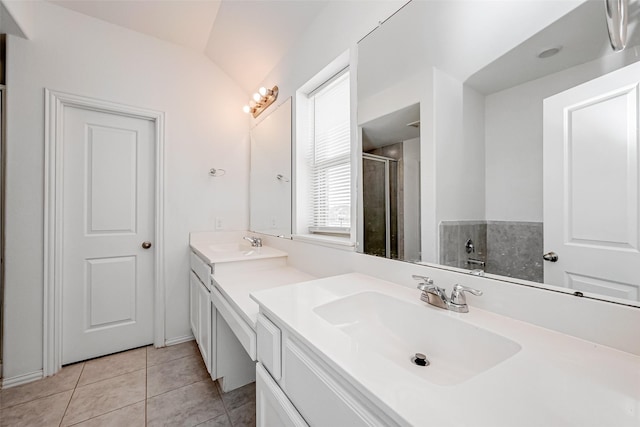 bathroom featuring vanity, vaulted ceiling, tile patterned floors, and walk in shower