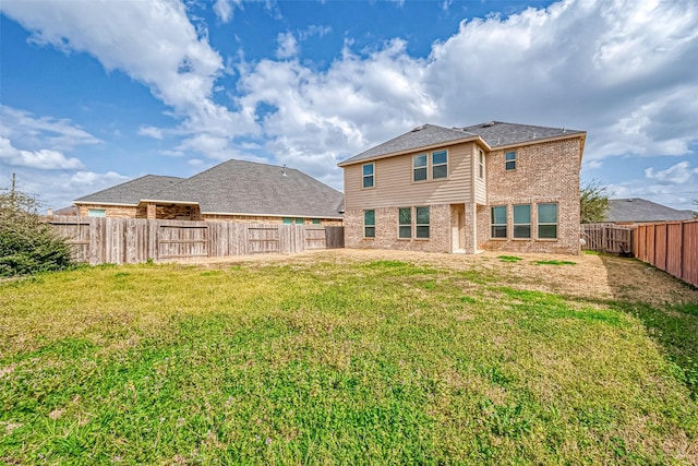 back of house with a yard