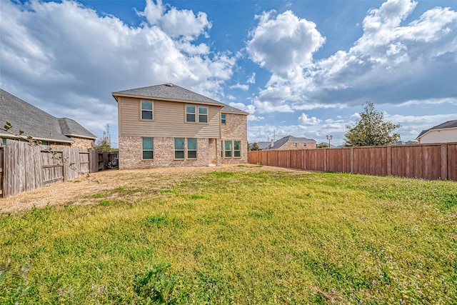 rear view of property with a yard