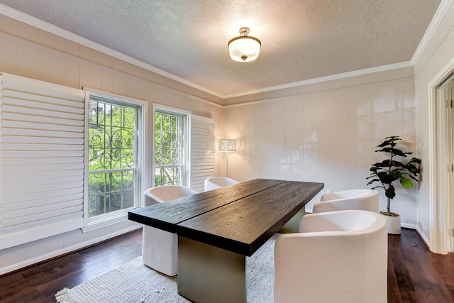 dining area with ornamental molding, dark hardwood / wood-style flooring, and a textured ceiling