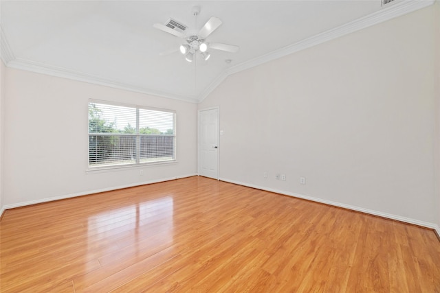 empty room featuring ornamental molding, vaulted ceiling, ceiling fan, and light wood-type flooring