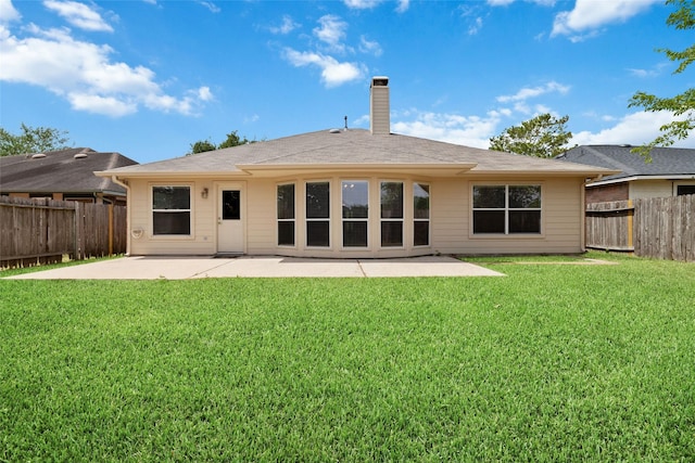 back of house with a patio and a lawn