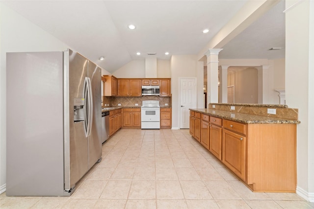 kitchen with stone counters, vaulted ceiling, decorative columns, backsplash, and stainless steel appliances