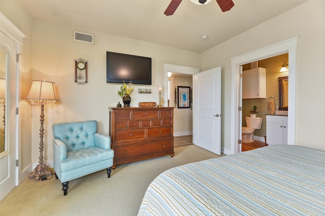 carpeted bedroom featuring ceiling fan and connected bathroom