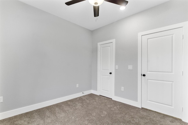 unfurnished room featuring carpet, ceiling fan, and baseboards