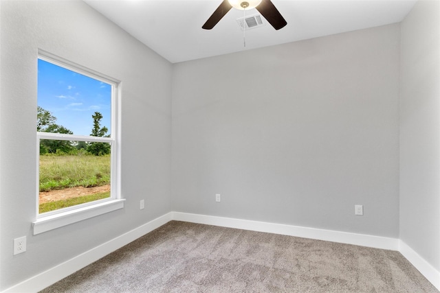 carpeted empty room featuring ceiling fan