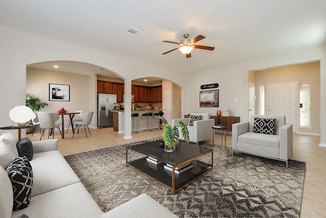 tiled living room featuring ceiling fan