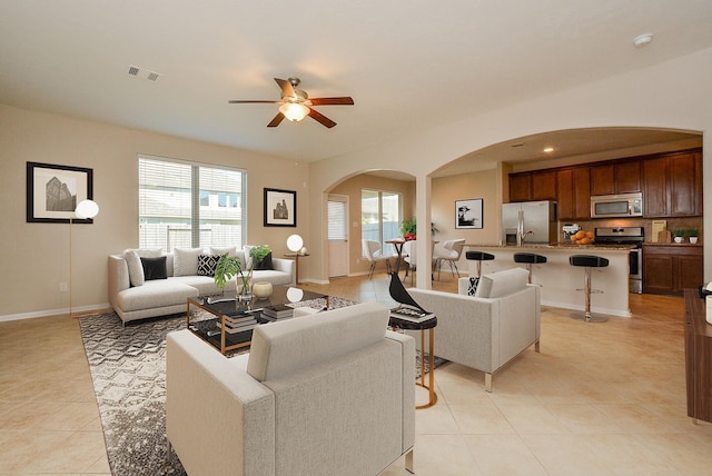 tiled living room featuring ceiling fan