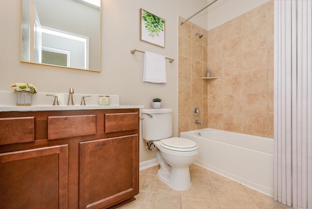 full bathroom with tile patterned flooring, vanity, tiled shower / bath combo, and toilet