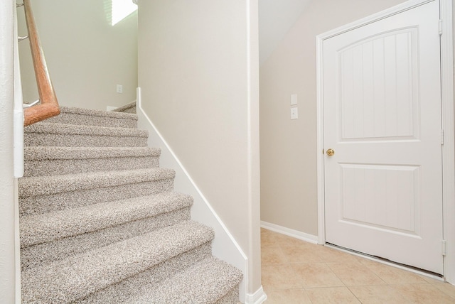 stairway featuring tile patterned flooring