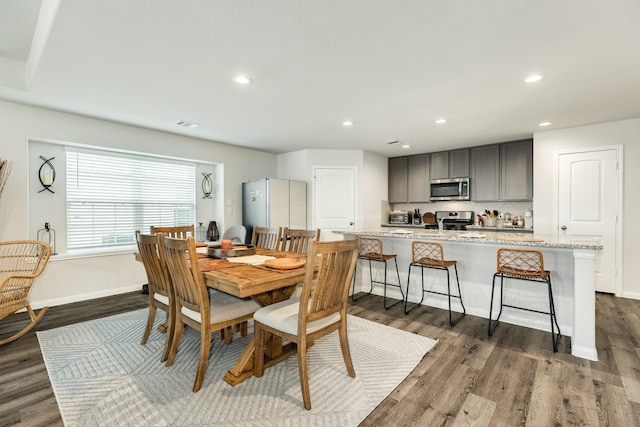 dining space with dark wood-type flooring