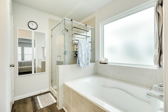 bathroom with shower with separate bathtub and hardwood / wood-style floors