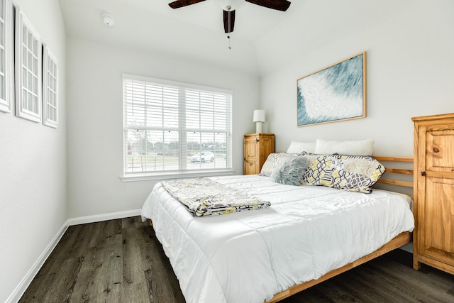 bedroom with dark hardwood / wood-style flooring and ceiling fan