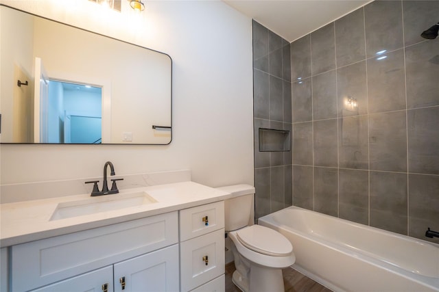 full bathroom featuring vanity, toilet, and tiled shower / bath