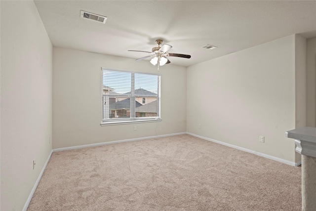 unfurnished room featuring ceiling fan and light colored carpet