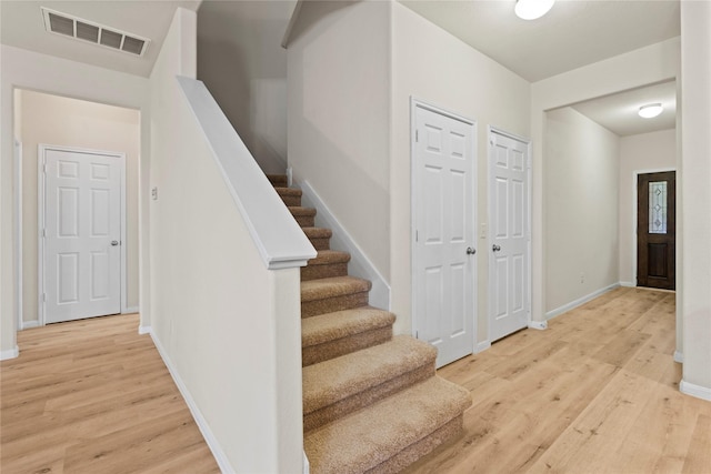 staircase featuring hardwood / wood-style flooring