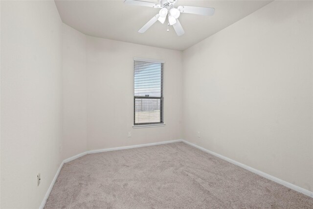 spare room with light carpet and ceiling fan