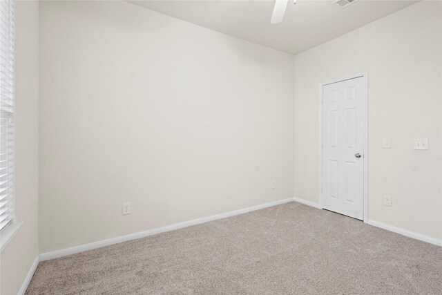 spare room featuring carpet and ceiling fan