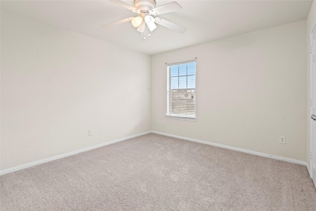 spare room featuring carpet flooring and ceiling fan