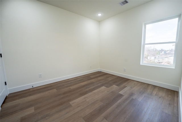 spare room featuring dark hardwood / wood-style floors