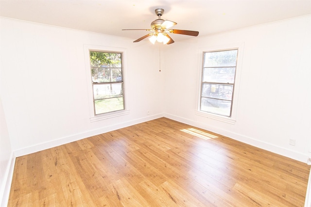 spare room with a healthy amount of sunlight, light wood-style flooring, and baseboards