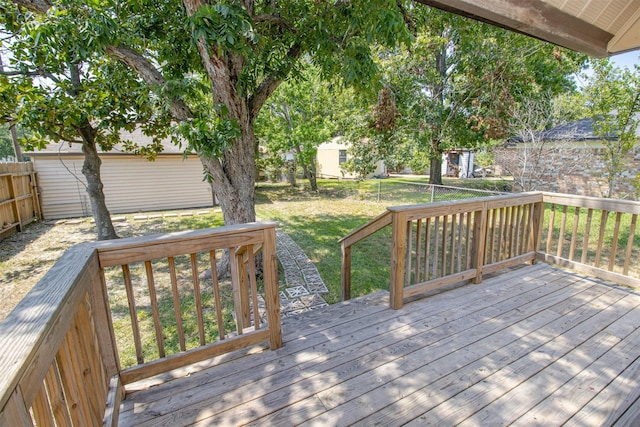 wooden terrace with a fenced backyard