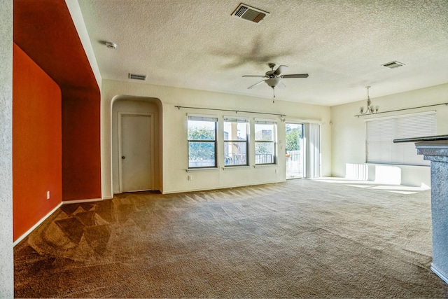 unfurnished living room featuring dark carpet, ceiling fan with notable chandelier, and a textured ceiling