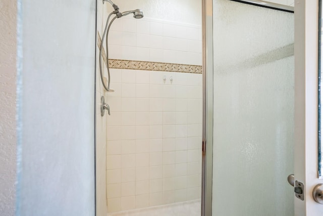 bathroom with a shower with door