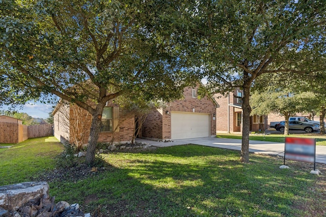 obstructed view of property featuring a garage and a front yard