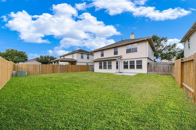 back of property featuring a patio and a lawn