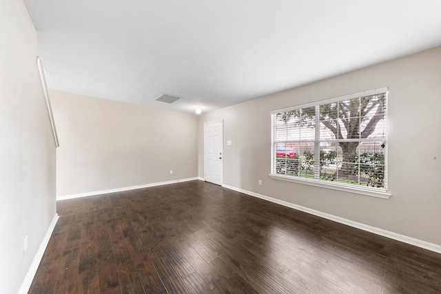 spare room with hardwood / wood-style floors