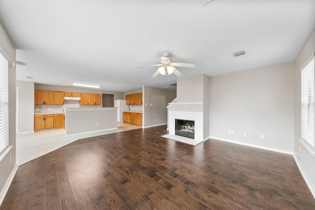 unfurnished living room with ceiling fan and light hardwood / wood-style flooring