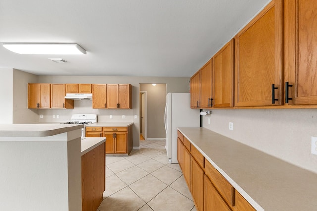 kitchen with light tile patterned floors and white appliances